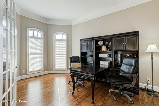 home office with baseboards, wood finished floors, and crown molding