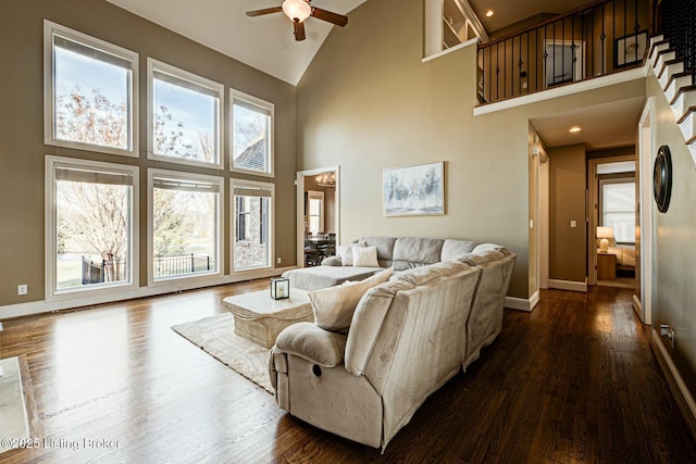 living area with ceiling fan, baseboards, and dark wood finished floors