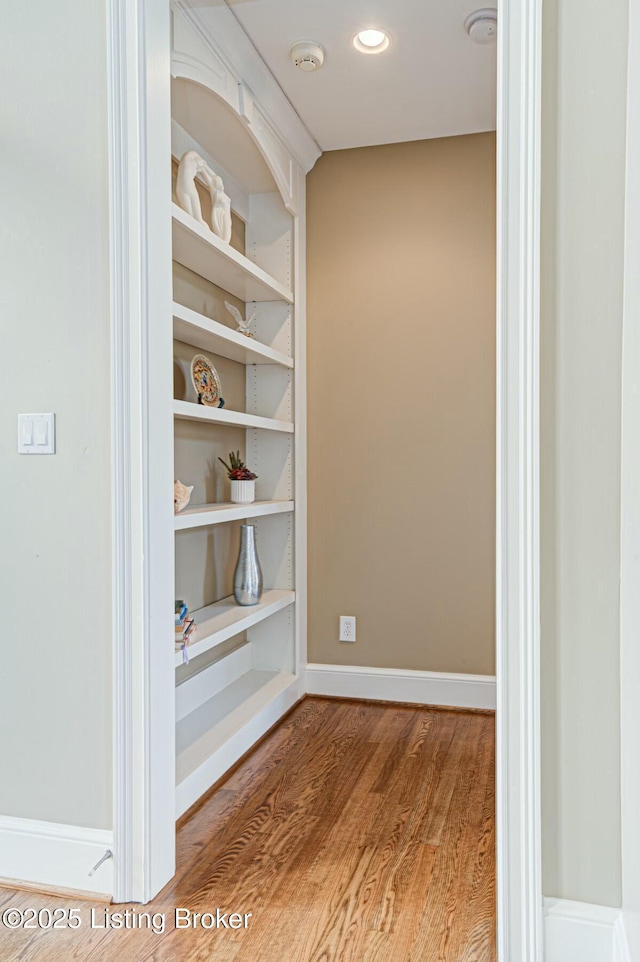 details with built in shelves, recessed lighting, wood finished floors, and baseboards