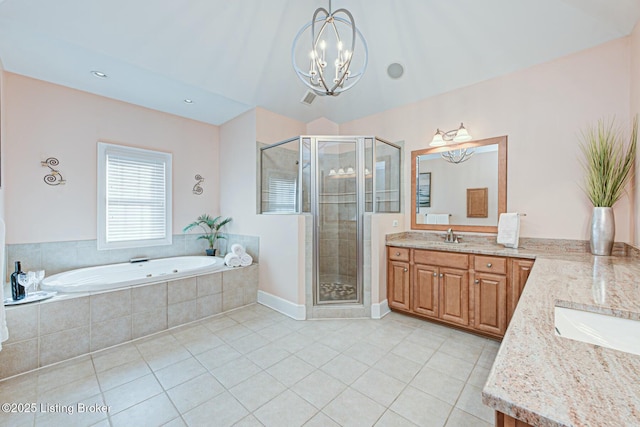 bathroom featuring tile patterned floors, a shower stall, a bath, and vanity