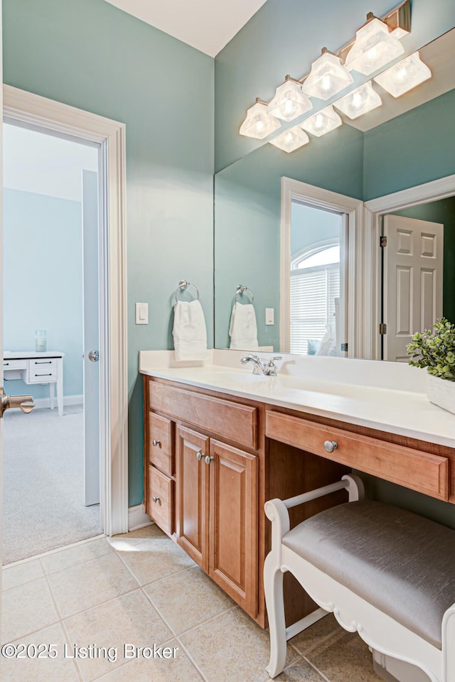 bathroom with tile patterned flooring, vanity, and baseboards