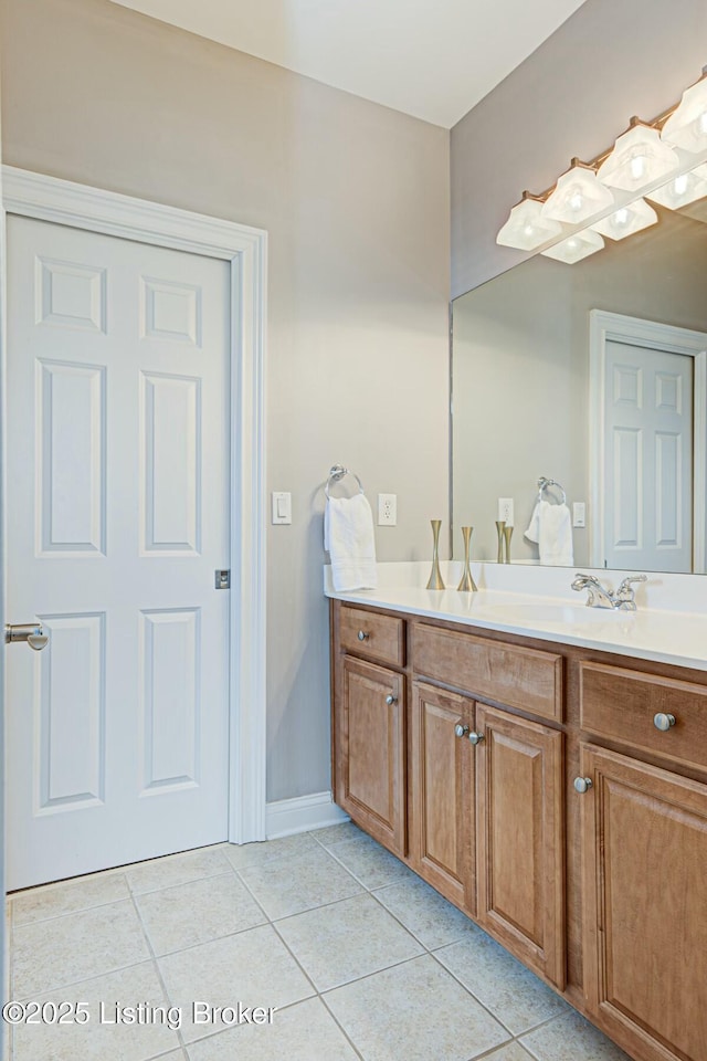 bathroom featuring baseboards, vanity, and tile patterned floors