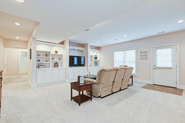 living room featuring light carpet, baseboards, and recessed lighting