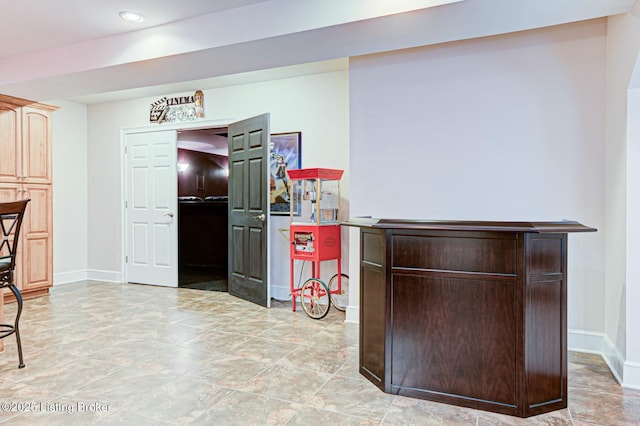 bar with recessed lighting and baseboards