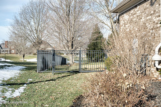 view of gate featuring a yard and fence