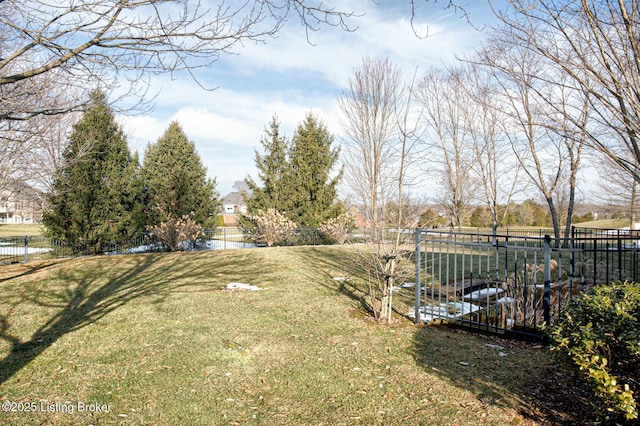 view of yard featuring a water view and fence