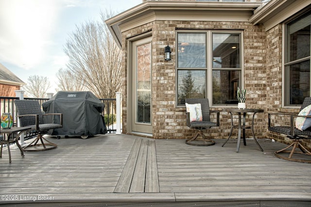 wooden terrace featuring area for grilling