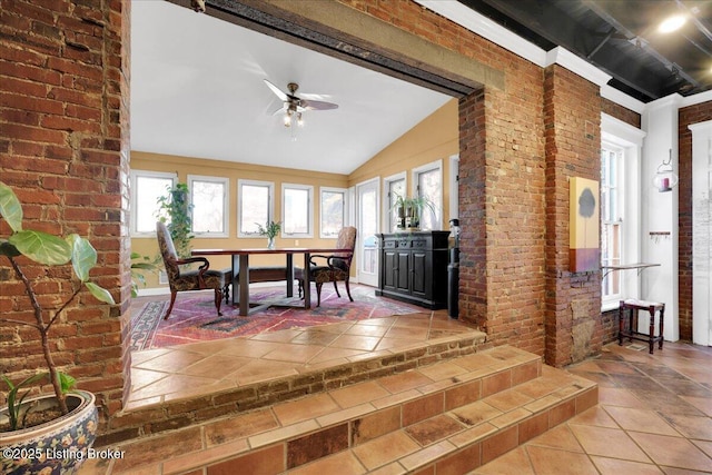 sunroom featuring vaulted ceiling and ceiling fan