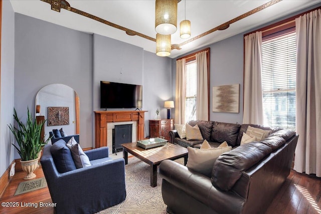 living room with hardwood / wood-style floors and a notable chandelier