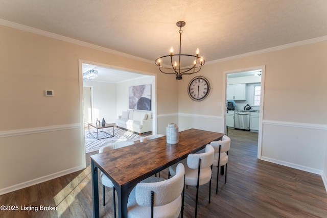 dining area with crown molding, dark wood-type flooring, and a chandelier