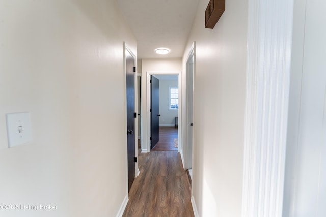 hallway featuring dark hardwood / wood-style flooring