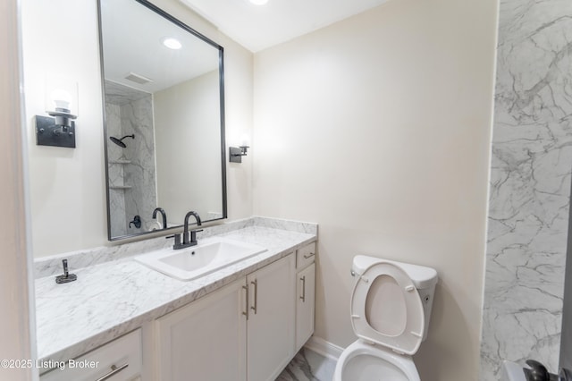 bathroom with walk in shower, vanity, and toilet