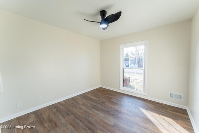 unfurnished room with dark hardwood / wood-style flooring and ceiling fan