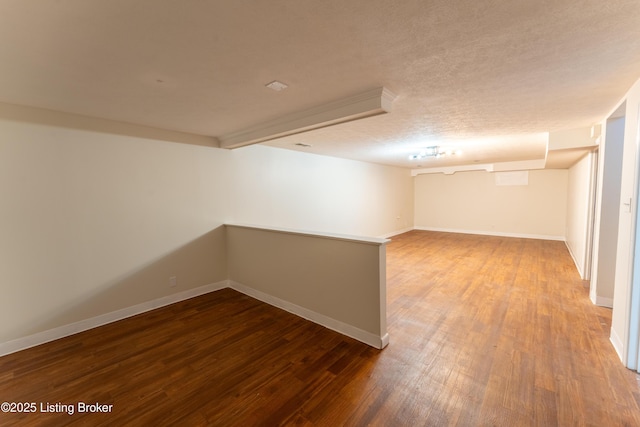 empty room with hardwood / wood-style floors and a textured ceiling