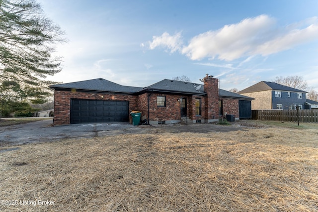 view of front of home with a garage and a front lawn