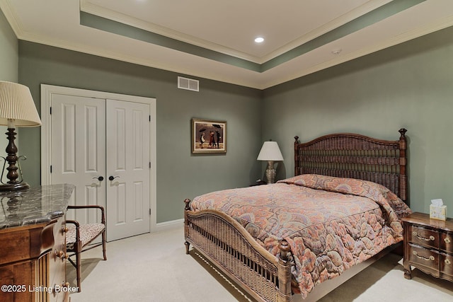 bedroom with ornamental molding, a tray ceiling, visible vents, and light carpet