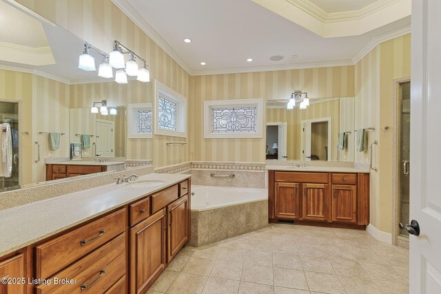 bathroom with crown molding, two vanities, wallpapered walls, tile patterned flooring, and a bath