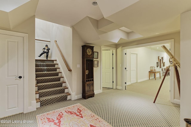 stairway featuring carpet and baseboards