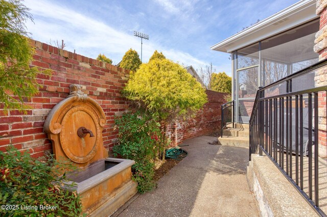 exterior space featuring fence and a sunroom