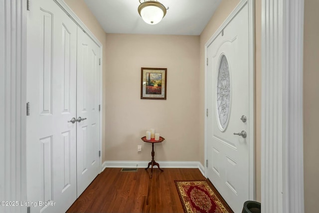 entryway with dark wood-type flooring