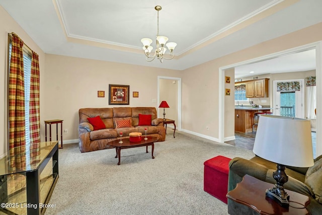 living room featuring a raised ceiling, ornamental molding, light carpet, and a chandelier