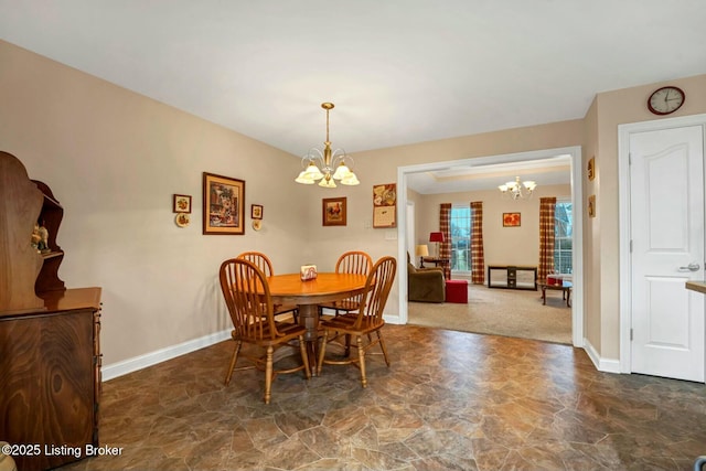 dining area featuring an inviting chandelier