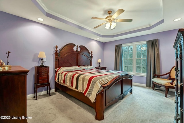 bedroom featuring crown molding, light colored carpet, ceiling fan, and a tray ceiling