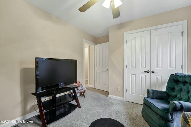 interior space featuring light colored carpet and ceiling fan