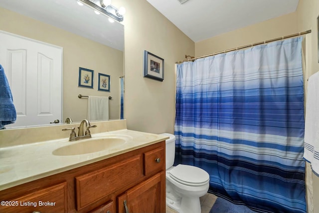 bathroom with vanity, toilet, and curtained shower