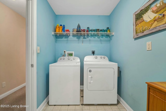 laundry area featuring washer and clothes dryer and light tile patterned floors