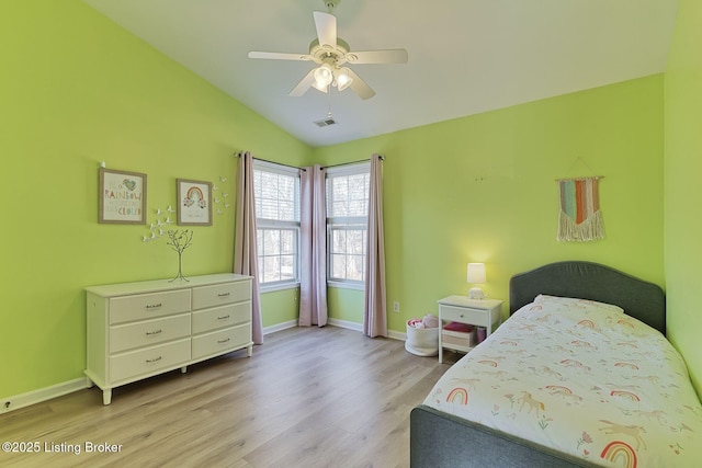 bedroom with vaulted ceiling, ceiling fan, and light wood-type flooring