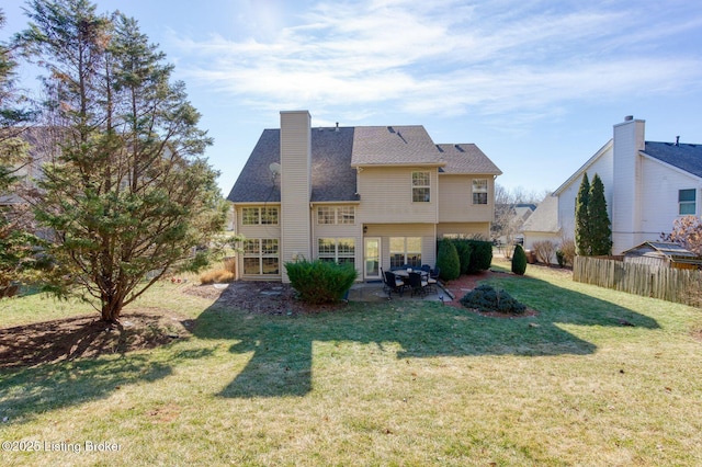 rear view of property with a patio and a yard