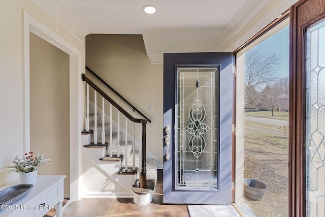 entryway with crown molding and hardwood / wood-style flooring