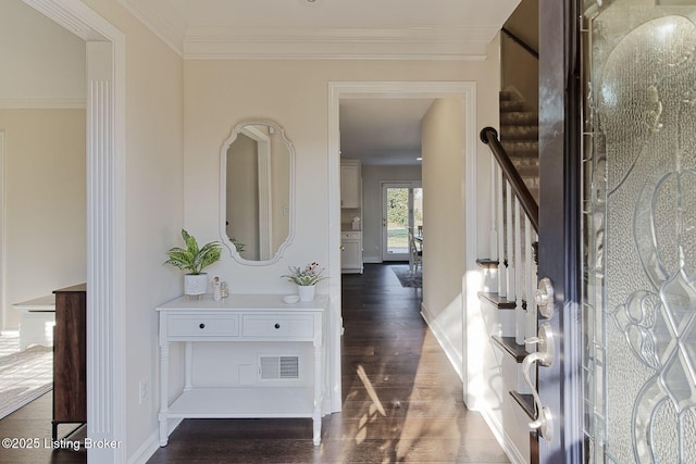 foyer entrance featuring crown molding and dark hardwood / wood-style flooring