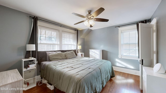 bedroom with dark hardwood / wood-style floors and ceiling fan