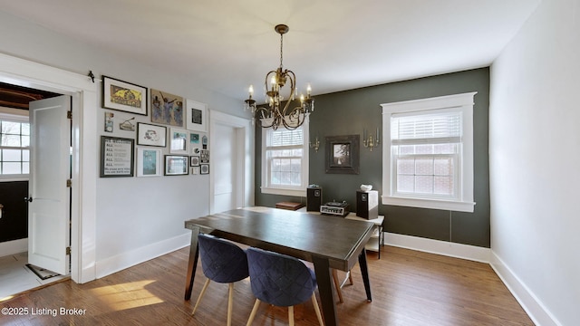 dining room featuring plenty of natural light, a chandelier, and hardwood / wood-style floors