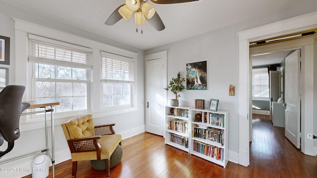 living area featuring hardwood / wood-style flooring, plenty of natural light, and ceiling fan