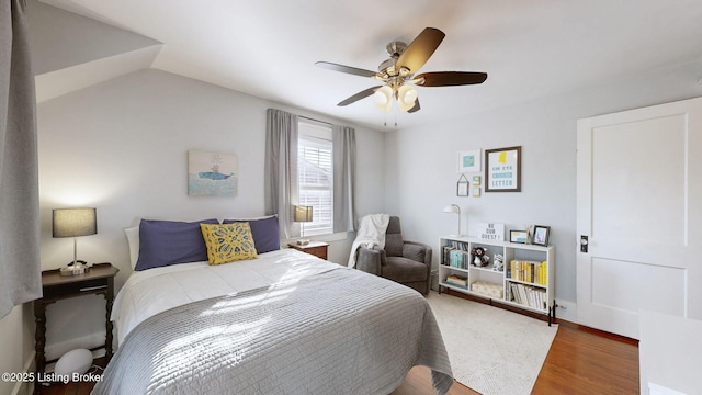 bedroom with lofted ceiling, wood-type flooring, and ceiling fan