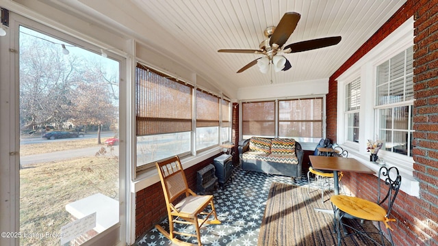 sunroom / solarium featuring ceiling fan