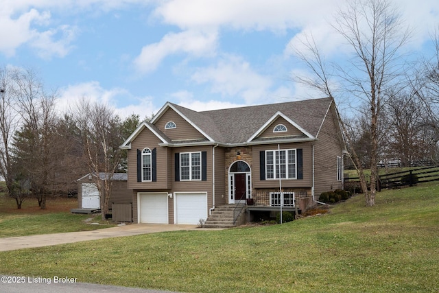 raised ranch featuring a garage and a front yard