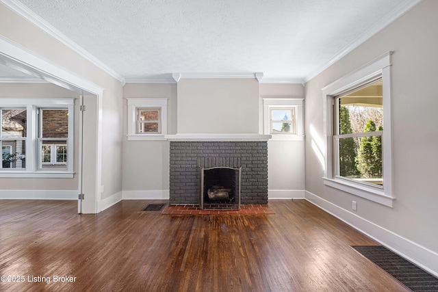 unfurnished living room with ornamental molding, dark hardwood / wood-style floors, a textured ceiling, and a fireplace