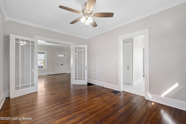 empty room with french doors, dark hardwood / wood-style floors, crown molding, and ceiling fan