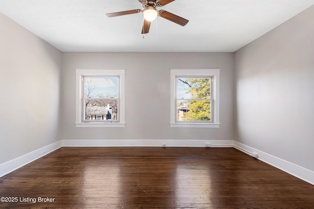 unfurnished room featuring dark wood-type flooring, a wealth of natural light, and ceiling fan