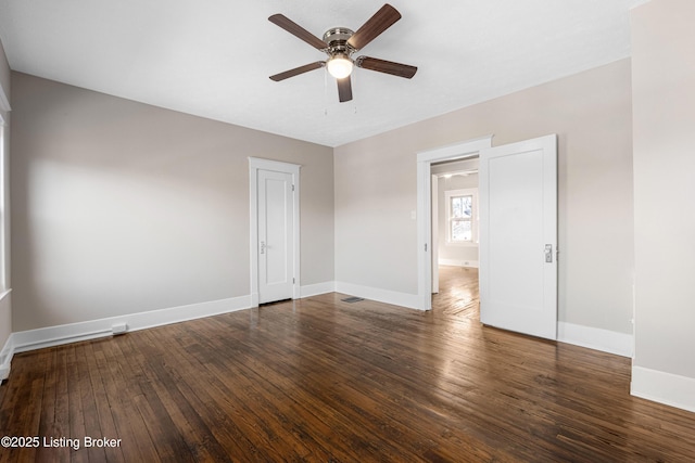 spare room featuring ceiling fan and dark hardwood / wood-style flooring