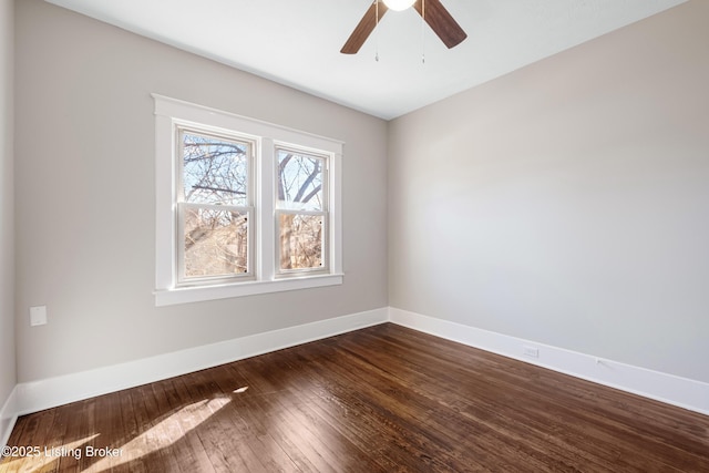 empty room featuring dark hardwood / wood-style flooring and ceiling fan