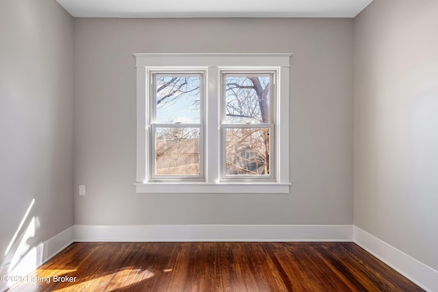 spare room with dark hardwood / wood-style floors