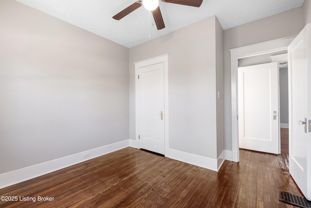 unfurnished bedroom featuring dark hardwood / wood-style floors and ceiling fan