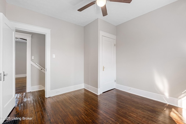 unfurnished bedroom featuring dark wood-type flooring and ceiling fan