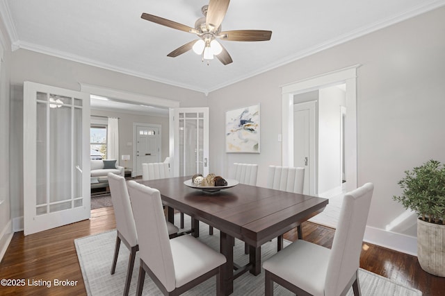 dining room with ornamental molding, dark hardwood / wood-style floors, ceiling fan, and french doors