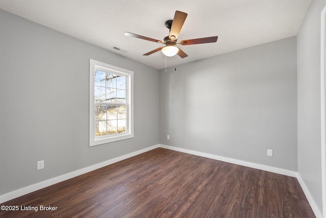 unfurnished room featuring dark hardwood / wood-style floors and ceiling fan